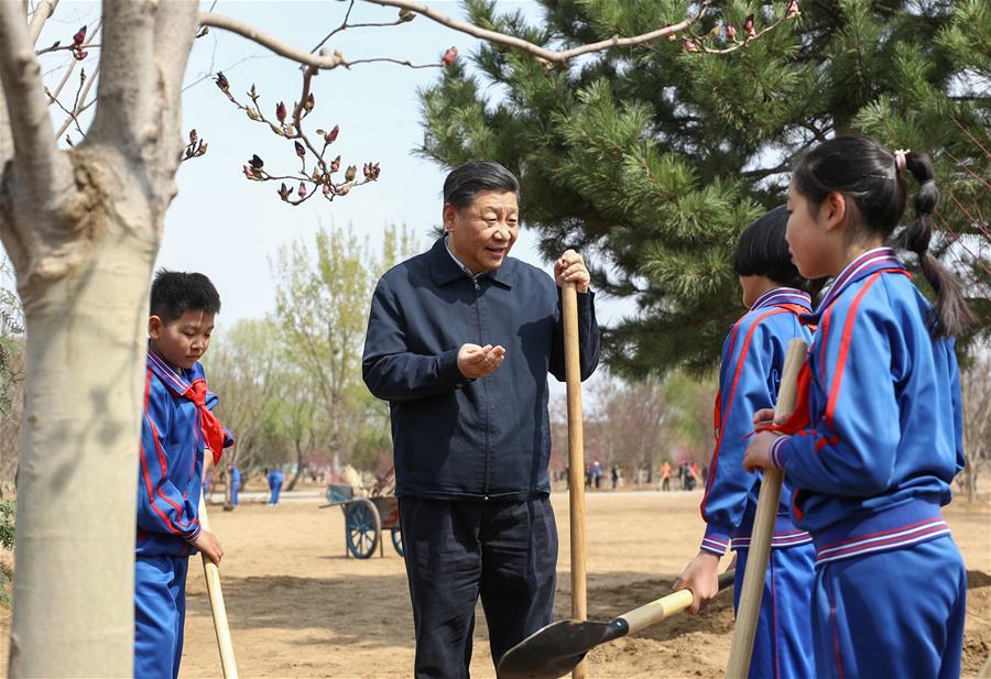 Chinese President Xi Jinping, also general secretary of the Communist Party of China Central Committee and chairman of the Central Military Commission, talks with school children as he attends a tree-planting activity in Tongzhou District in Beijing, capital of China, April 8, 2019. Other Party and state leaders, including Li Zhanshu, Wang Yang, Wang Huning, Zhao Leji, Han Zheng and Wang Qishan, also attended the activity. (Xinhua/Ju Peng)
