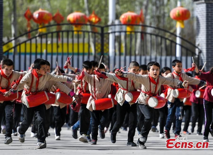 Photo shows students from a primary school in Wushi County, in northwest China\'s Xinjiang Uygur Autonomous Region learning waist drum, April 8, 2019. (Photo/China News Service)