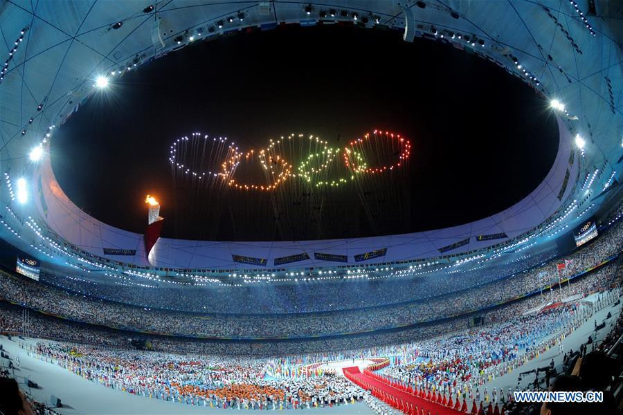Photo taken on Aug. 8, 2008 shows the fireworks in the shape of Olympic rings during the opening ceremony of the Beijing Olympic Games held in the National Stadium, also known as the Bird\'s Nest, in north Beijing, China. From sending athletes to Helsinki Summer Olympic Games for the very first time in 1952 to winning the bid to host 2022 Winter Olympic Games in 2015, the People\'s Republic of China went through a remarkable history of sports, including successfully hosting the 2008 Summer Olympic Games and preparing for the upcoming 2022 Winter Olympic Games. (Xinhua/Ma Zhancheng)