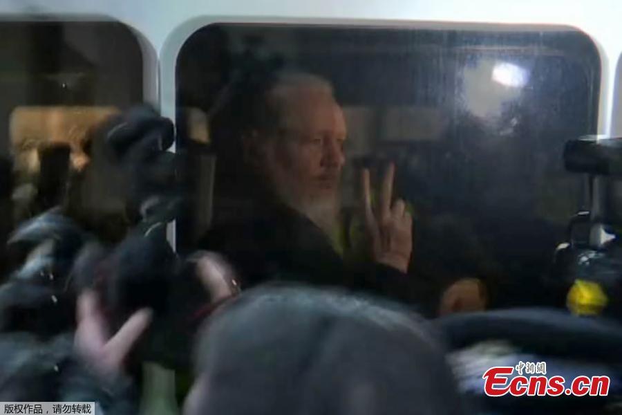 WikiLeaks founder Julian Assange is seen in a police van after he was arrested by British police outside the Ecuadorian embassy in London, Britain April 11, 2019. British police dragged WikiLeaks founder Julian Assange out of Ecuador\'s embassy on Thursday after his seven-year asylum was revoked, paving the way for his extradition to the United States for one of the biggest ever leaks of classified information. (Photo/Agencies)