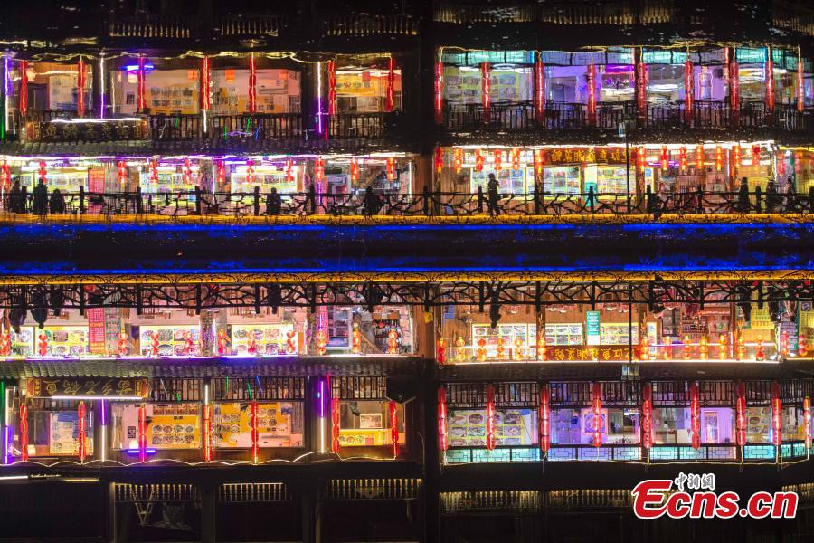 Illuminated buildings are reflected in the Tuojiang River in Fenghuang Ancient Town, Hunan Province, April 11, 2019. The old town is famous for its time-honored buildings and cultural relics, attracting large numbers of visitors each year from China and abroad. (Photo: China News Service/Yang Huafeng)