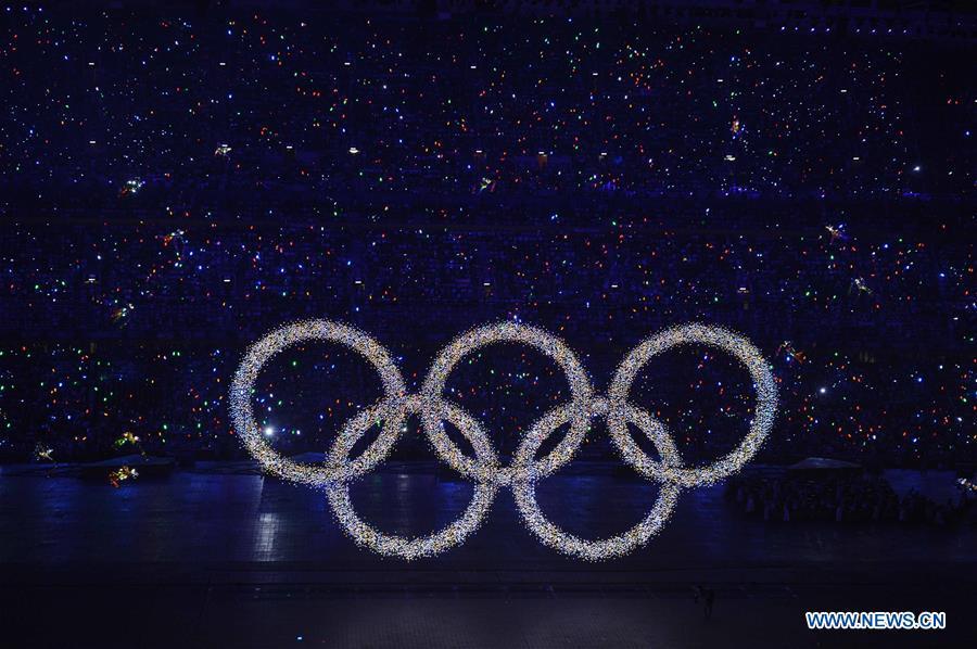 Photo taken on Aug. 8, 2008 shows the shining Olympic rings on a huge LED screen, proclaiming the arrival of the Olympiad, during the opening ceremony of the Beijing 2008 Olympic Games in the National Stadium, or the Bird\'s Nest, Beijing, capital of China. From sending athletes to Helsinki Summer Olympic Games for the very first time in 1952 to winning the bid to host 2022 Winter Olympic Games in 2015, the People\'s Republic of China went through a remarkable history of sports, including successfully hosting the 2008 Summer Olympic Games and preparing for the upcoming 2022 Winter Olympic Games. (Xinhua/Yang Lei)