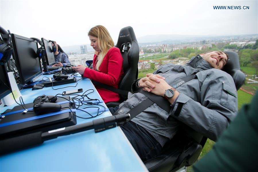 Gamers participate in Gaming in the Sky competition on a platform lifted by a crane in Zagreb, Croatia, April 13, 2019. (Xinhua/Filip Kos)