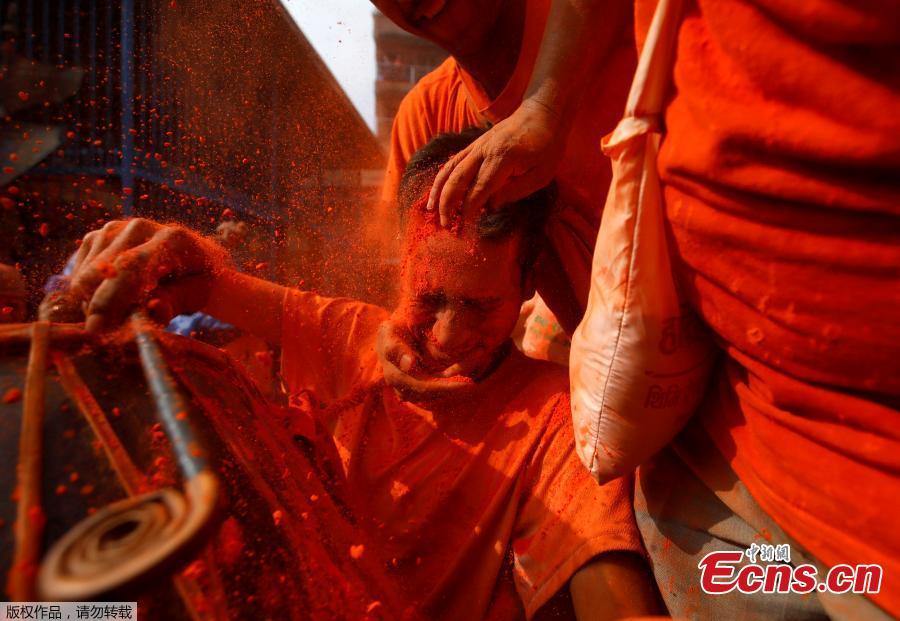 Nepalese devotees throw vermilion powder to each other to celebrate Sindoor Jatra Festival at Thimi in Bhaktapur, Nepal, April 15, 2019. The festival is celebrated to welcome the Nepalese New Year and the beginning of the spring season in Nepal.  (Photo/Agencies)
