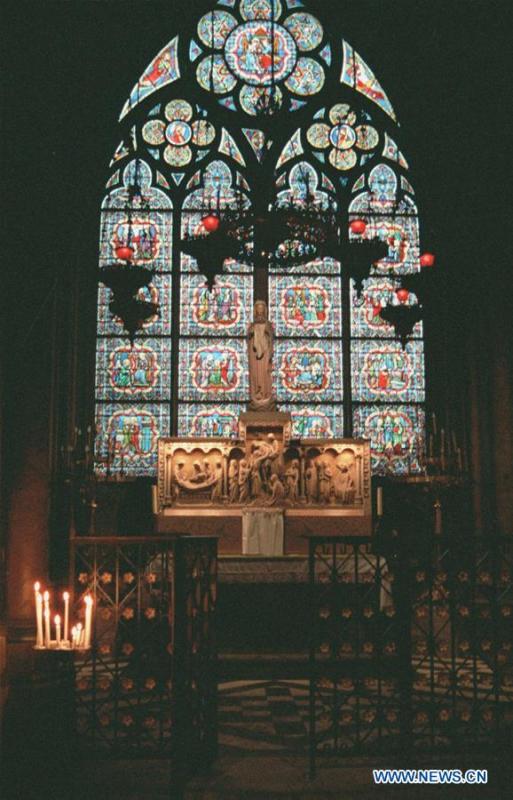 File photo taken in 2000 shows a stained-glass window depicting scenes from the Old Testament at the Notre Dame Cathedral in Paris, France. The devastating fire at Notre Dame Cathedral in central Paris has been put out after burning for 15 hours, local media reported on April 16, 2019. In early evening on April 15, a fire broke out in the famed cathedral. Online footage showed thick smoke billowing from the top of the cathedral and huge flames between its two bell towers engulfing the spire and the entire roof which both collapsed later. Notre Dame is considered one of the finest examples of French Gothic architecture which receives about 12 million visitors every year. (Xinhua/Xu Youzhu)