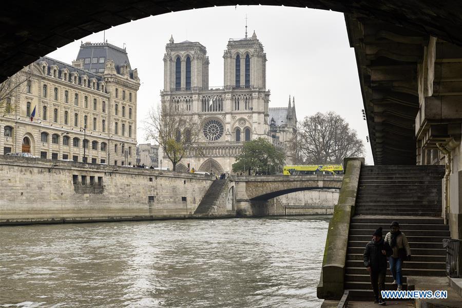 File photo taken on Dec. 2, 2016 shows the Notre Dame Cathedral by the River Seine in Paris, France. The devastating fire at Notre Dame Cathedral in central Paris has been put out after burning for 15 hours, local media reported on April 16, 2019. In early evening on April 15, a fire broke out in the famed cathedral. Online footage showed thick smoke billowing from the top of the cathedral and huge flames between its two bell towers engulfing the spire and the entire roof which both collapsed later. Notre Dame is considered one of the finest examples of French Gothic architecture which receives about 12 million visitors every year. (Xinhua/Chen Yichen)
