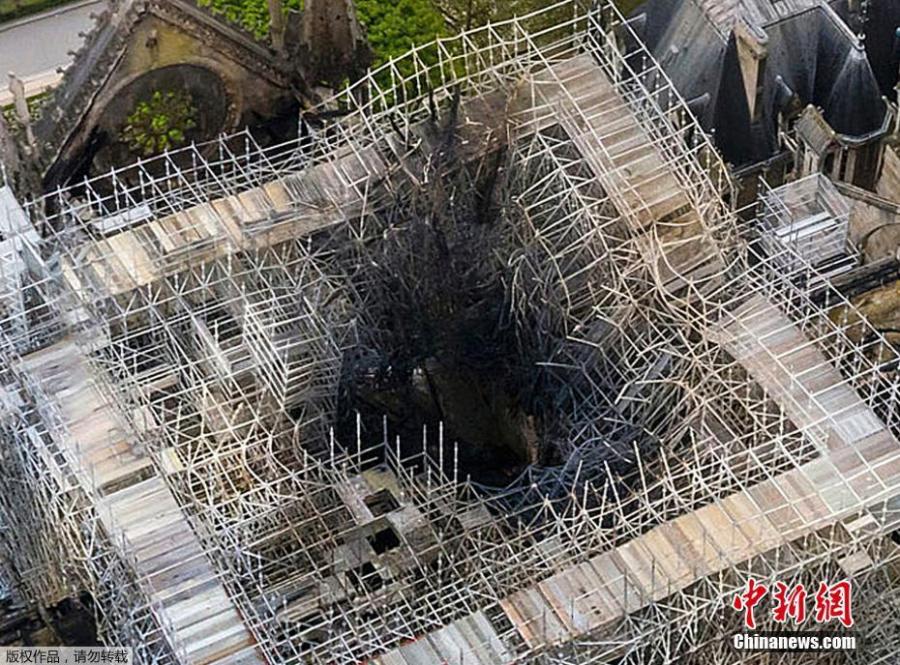Aerial photo reveals the roof of the building was destroyed by the blaze, which burned for nine hours before being extinguished. The French president, Emmanuel Macron, has vowed to rebuild the Paris landmark within five years. The fire started at the base of the 93-metre spire and spread through the cathedral\'s ribbed roof, made up of hundreds of oak beams, some dating back to the 13th century. (Photo/Agencies)