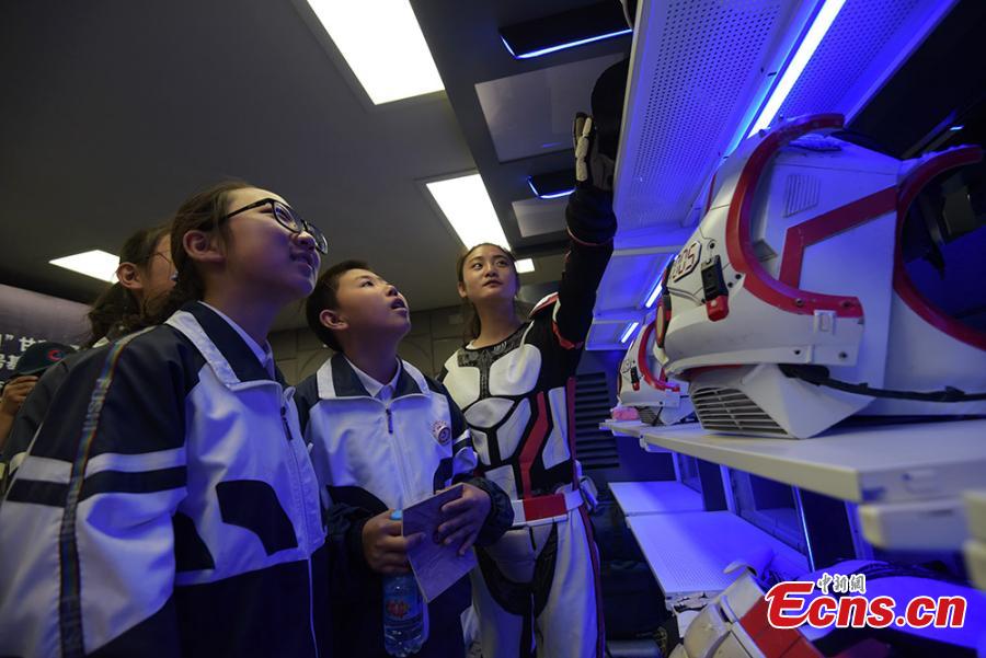 Photo taken on April 17, 2019 shows Chinese students tour the site features an \'extravehicular site\' for visitors to experience a trip on the \'Martian surface\' in mock spacesuits.  (Photo/China News Service)