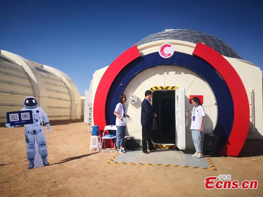 Photo taken on April 17, 2019 shows a staff standing at an entrance to \