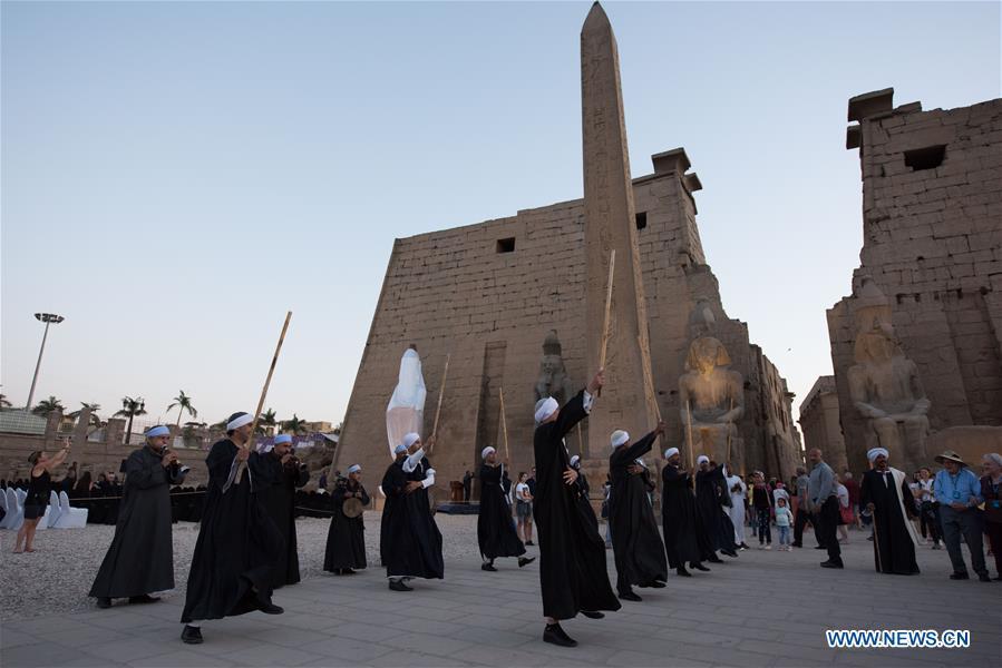 People attend the unveiling of a colossus of ancient Egyptian King Ramses II at Luxor Temple in Luxor, Egypt, April 18, 2019. Egypt\'s Ministry of Antiquities unveiled on Thursday evening a 60-ton statue of ancient Egyptian King Ramses II at the Luxor Temple after its restoration and re-erection on the Nile River\'s east bank in the southern province of Luxor. (Xinhua/Meng Tao)
