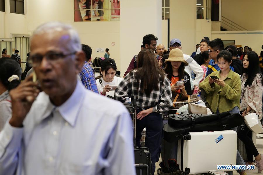 Passengers queue up for taxi at the Bandaranaike International Airport in Colombo, Sri Lanka, April 22, 2019. The death toll from the multiple blasts that ripped through Sri Lanka on Sunday rose to 228 while 450 others were injured, local media quoting hospital sources said. (Xinhua/Wang Shen)