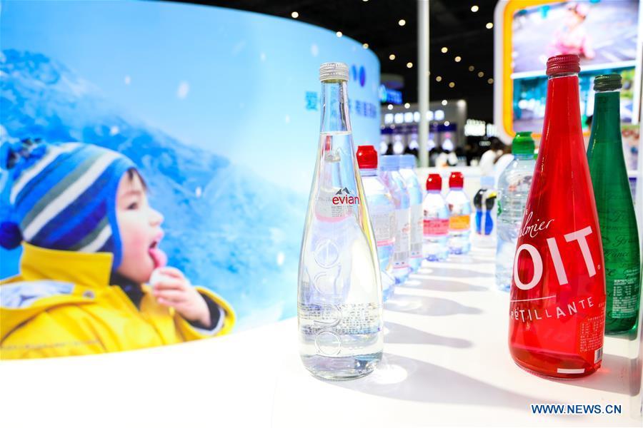 Photo taken on Nov. 7, 2018 shows bottled water and Aquadrink of Danone displayed at the Food & Agricultural Products area of the first China International Import Expo (CIIE) in Shanghai, east China. Food of a particular place is an important symbol of local geographic and cultural characteristics. Food carries history and tradition, leads the tide of trade, strengthens diplomatic relations, disseminates and promotes culture. Food has been serving as connections between people around the world. In ancient times, food such as grapes, pomegranates, walnuts, coriander, cucumbers and sesame seeds were introduced to China along the Silk Road. Nowadays, thanks to the Belt and Road Initiative, red wine, coffee, dried fruits, meat, seafood, and dairy products from foreign countries enter the homes of ordinary people, turning daily meals into feasts with exotic cuisines. (Xinhua/Liu Dawei)