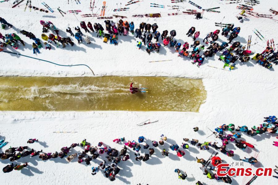 A skier participates in a waterslide contest at the \