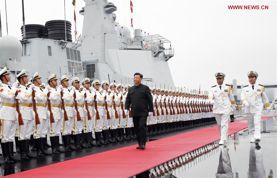 Chinese President and Central Military Commission Chairman Xi Jinping inspects the honor guards of the Chinese People\'s Liberation Army (PLA) Navy before boarding the destroyer Xining at a pier in Qingdao, east China\'s Shandong Province, on April 23, 2019. Xi, also general secretary of the Communist Party of China Central Committee, is here to review a naval parade staged to mark the 70th founding anniversary of the PLA Navy. (Xinhua/Li Gang)