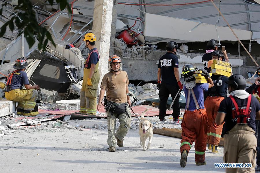 Rescuers search for victims at a collapsed building in Pampanga Province, the Philippines, April 23, 2019. The death toll from the 6.1-magnitude earthquake that struck the Philippines\' main Luzon Island rose to nine, local officials said on Tuesday. (Xinhua/Rouelle Umali)