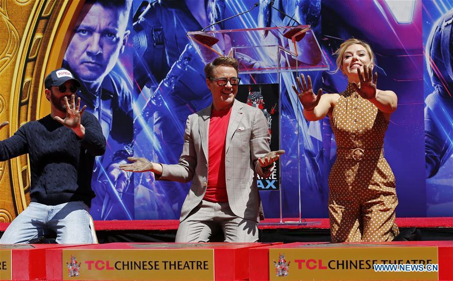 Actor Robert Downey Jr. (C), Chris Evans (L) and actress Scarlett Johansson show their hands after putting their handprints in cement during print ceremony in the forecourt of the TCL Chinese Theater in Los Angeles, the United States, April 23, 2019. The cast of Marvel Studios \