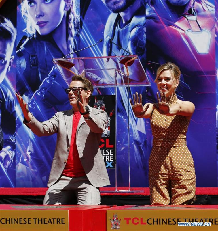 Actor Robert Downey Jr. (L) and actress Scarlett Johansson show their hands after putting their handprints in cement during print ceremony in the forecourt of the TCL Chinese Theater in Los Angeles, the United States, April 23, 2019. The cast of Marvel Studios \