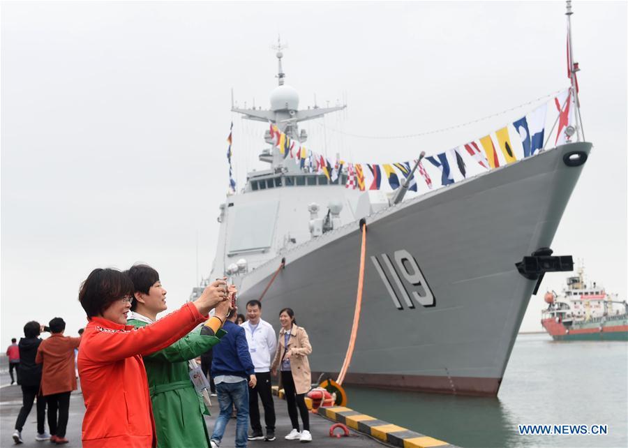 Visitors take photos of the guided-missile destroyer Guiyang of the Chinese People\'s Liberation Army (PLA) Navy during a warship open day event in Qingdao, east China\'s Shandong Province, April 24, 2019. A warship open day event was held on Wednesday in Qingdao, as part the multinational naval events marking the 70th founding anniversary of PLA Navy. (Xinhua/Wang Siwei)