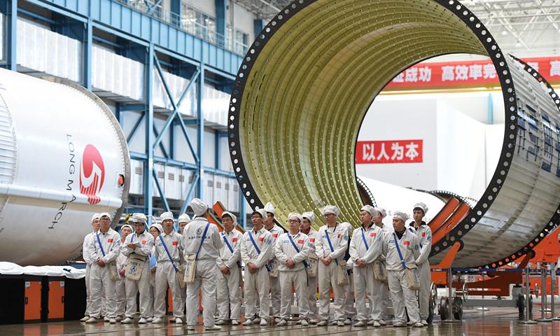 People work in the assembly and test workshop for China\'s Long March-5 rocket in the new generation launch vehicle industrialization base in Tianjin. April 24 is China\'s Space Day. China plans to launch the third of its large carrier rocket Long March-5 in July. The second Long March-5 rocket was launched from the Wenchang Space Launch Center in the southern province of Hainan on July 2, 2017, but a malfunction occurred less than six minutes after lift-off. (Photo provided by China Aerospace Science and Technology Corp.)