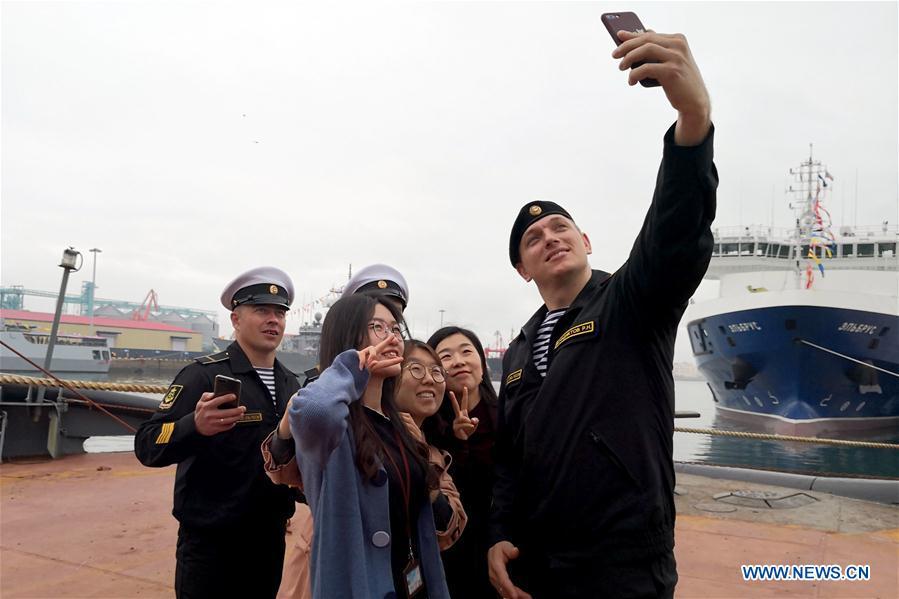 Crew members and visitors take a selfie on Russian Navy tug ship Nikolai Chiker during a warship open day event in Qingdao, east China\'s Shandong Province, April 24, 2019. A warship open day event was held on Wednesday in Qingdao, as part the multinational naval events marking the 70th founding anniversary of PLA Navy. (Xinhua/Yu Lan)
