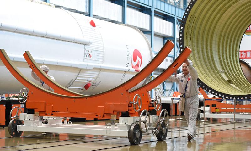 People work in the assembly and test workshop for China\'s Long March-5 rocket in the new generation launch vehicle industrialization base in Tianjin. April 24 is China\'s Space Day. China plans to launch the third of its large carrier rocket Long March-5 in July. The second Long March-5 rocket was launched from the Wenchang Space Launch Center in the southern province of Hainan on July 2, 2017, but a malfunction occurred less than six minutes after lift-off. (Photo provided by China Aerospace Science and Technology Corp.)