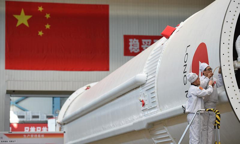 People work in the assembly and test workshop for China\'s Long March-5 rocket in the new generation launch vehicle industrialization base in Tianjin. April 24 is China\'s Space Day. China plans to launch the third of its large carrier rocket Long March-5 in July. The second Long March-5 rocket was launched from the Wenchang Space Launch Center in the southern province of Hainan on July 2, 2017, but a malfunction occurred less than six minutes after lift-off. (Photo provided by China Aerospace Science and Technology Corp.)