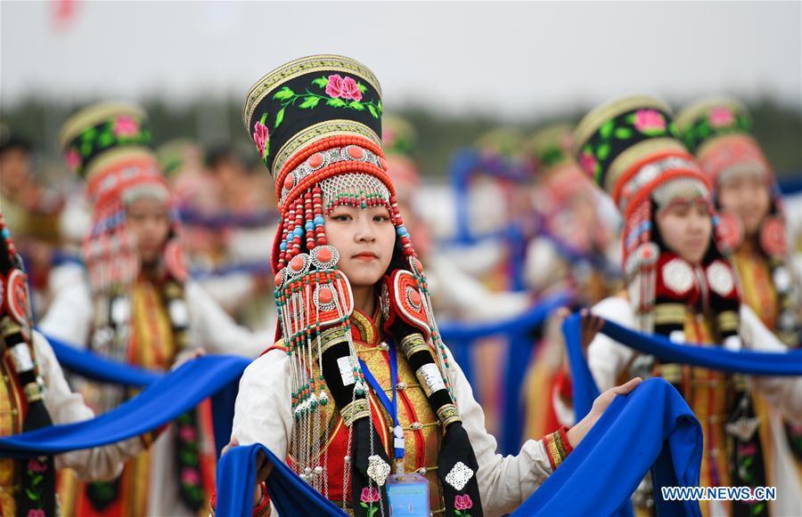 People dressed in traditional costumes perform at the Genghis Khan Chagan Suluk Nadam Fair in Ejin Horo Banner of Ordos City, north China\'s Inner Mongolia Autonomous Region, April 24, 2019. The two-day fair kicked off on Wednesday, including a variety of traditional activities. (Xinhua/Peng Yuan)