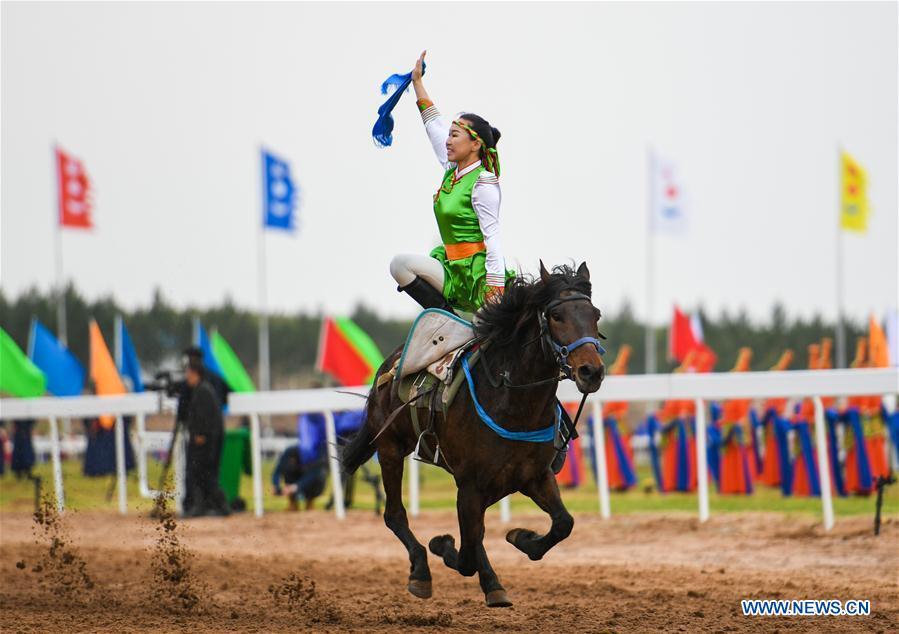 A woman performs horse riding at the Genghis Khan Chagan Suluk Nadam Fair in Ejin Horo Banner of Ordos City, north China\'s Inner Mongolia Autonomous Region, April 24, 2019. The two-day fair kicked off on Wednesday, including a variety of traditional activities. (Xinhua/Peng Yuan)