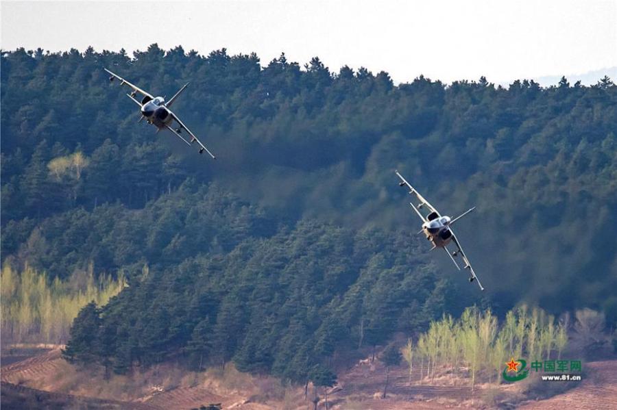 A PLA Air Force warplane in an ultra-low altitude flight training in a valley, April 25, 2019. (Photo/81.cn)