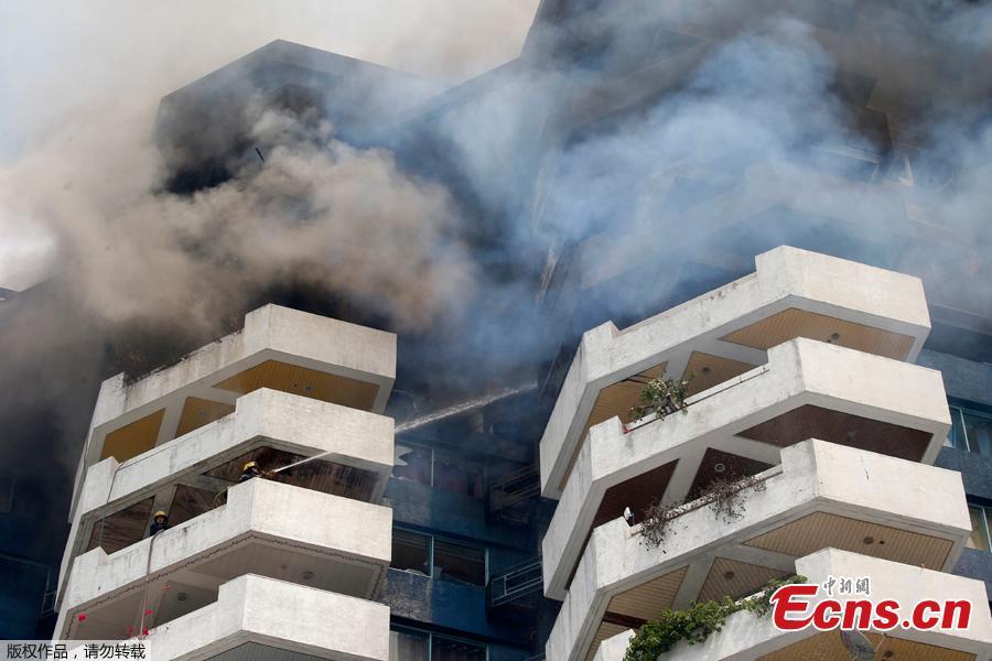 Fire burns in the top floors of a 21-story Pacific Coastal Plaza condominium in Manila, Philippines, April 29, 2019.  Officials say more than 100 firetrucks converged Monday to battle the blaze that hit the Pacific Coast Plaza condominium in the Paranaque city area of Manila, where one lane of a coastal road along Manila Bay was closed due to falling debris. A woman died in the accident. (Photo/Agencies)