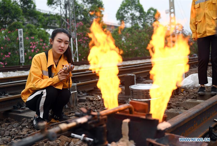 Gui Rubin, a railway worker born in 1993, is seen at a rail-change site near the Jinjicun Station in Nanning, south China\'s Guangxi Zhuang Autonomous Region, April 26, 2017. Gui is among eight female workers at a rail change and repair workshop of the Liuzhou section of Nanning Railway Bureau. They are responsible for changing and welding worn-out rails and turnouts along the railway line of thousands of kilometers under the jurisdiction of Nanning Railway Bureau. A nation will prosper only when its young people thrive; a country will be full of hope and have a great tomorrow only when its younger generations have ideals, ability, and a strong sense of responsibility. Young people always play a vanguard role in realizing national rejuvenation, which is the mission of the Chinese youth in the new era. In China many young people realize the value of life through hard work. They are writing a brilliant chapter worthy of our times in their efforts to take advantage of their youthful vigor, explore life and contribute to society. (Xinhua/Lu Boan)