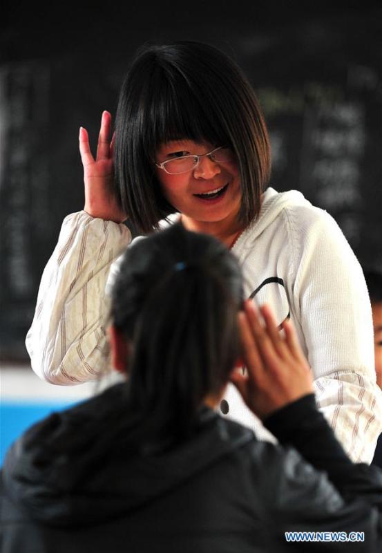 Xu Qianqian, a special education teacher born in 1986, interacts with a student at class in a special education school in Shenmu City, northwest China\'s Shaanxi Province, Sept. 20, 2011. A nation will prosper only when its young people thrive; a country will be full of hope and have a great tomorrow only when its younger generations have ideals, ability, and a strong sense of responsibility. Young people always play a vanguard role in realizing national rejuvenation, which is the mission of the Chinese youth in the new era. In China many young people realize the value of life through hard work. They are writing a brilliant chapter worthy of our times in their efforts to take advantage of their youthful vigor, explore life and contribute to society. (Xinhua/Huang Xiaobang)