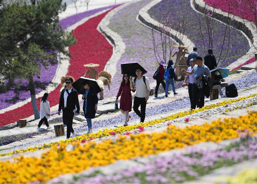 Tourists visit Beijing International Horticultural Exhibition in Yanqing District of Beijing, capital of China, on May 1, 2019. Beijing International Horticultural Exhibition welcomed its first tourist peak by serving more than 320,000 tourists during the four-day May Day holiday, the organizer said Saturday. Some 132 activities, including float parades, world ethnic and folk cultural performances, and culture and art carnivals staged by central and eastern European countries, were held during the holiday. With the theme of \
