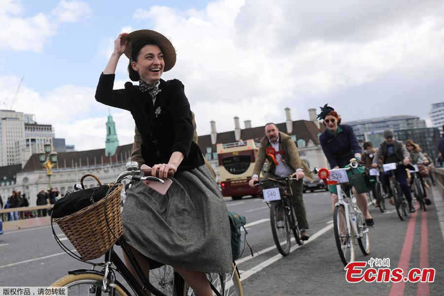 Participants ride their bicycles as they take part in the annual Tweed Run across London, Britain May 4, 2019. They ride through London\'s historic streets, stopping mid way for a picnic and ending with a traditional British \