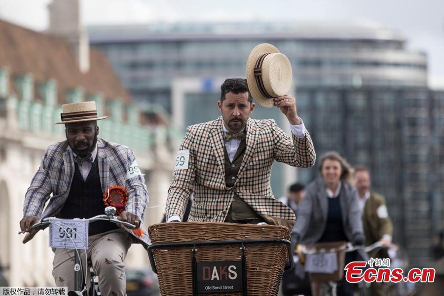 A participant gestures with his hat as he rides across Westminster Bridge during the annual Tweed Run across London, Britain May 4, 2019. (Photo/Agencies)