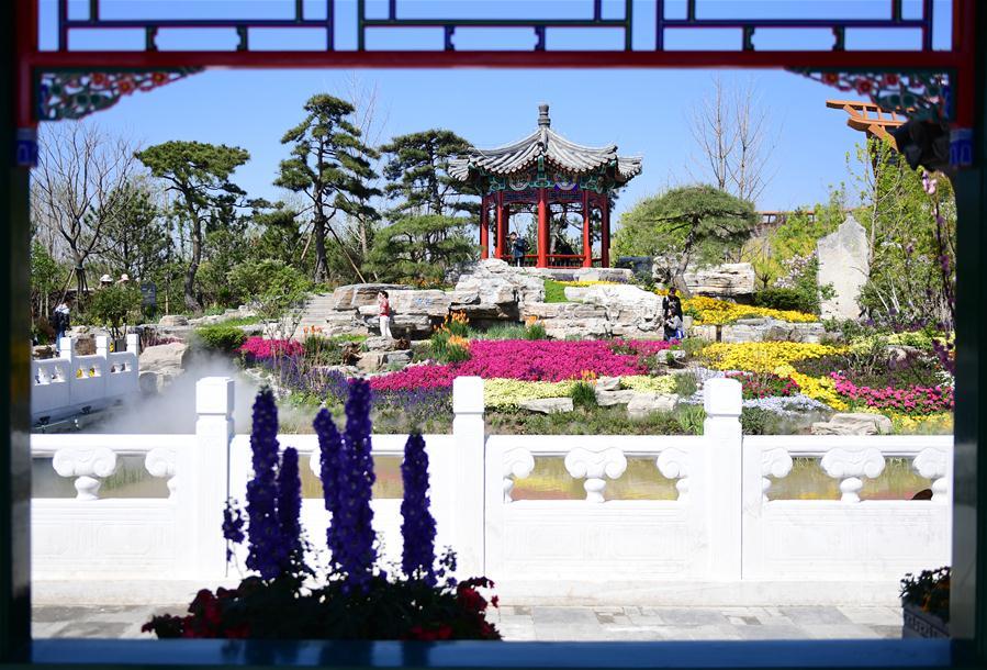 Visitors are seen at the Beijing Garden at the International Horticultural Exhibition 2019 Beijing in Yanqing District of Beijing, capital of China, May 1, 2019. Beijing International Horticultural Exhibition welcomed its first tourist peak by serving more than 320,000 tourists during the four-day May Day holiday, the organizer said Saturday. Some 132 activities, including float parades, world ethnic and folk cultural performances, and culture and art carnivals staged by central and eastern European countries, were held during the holiday. With the theme of \