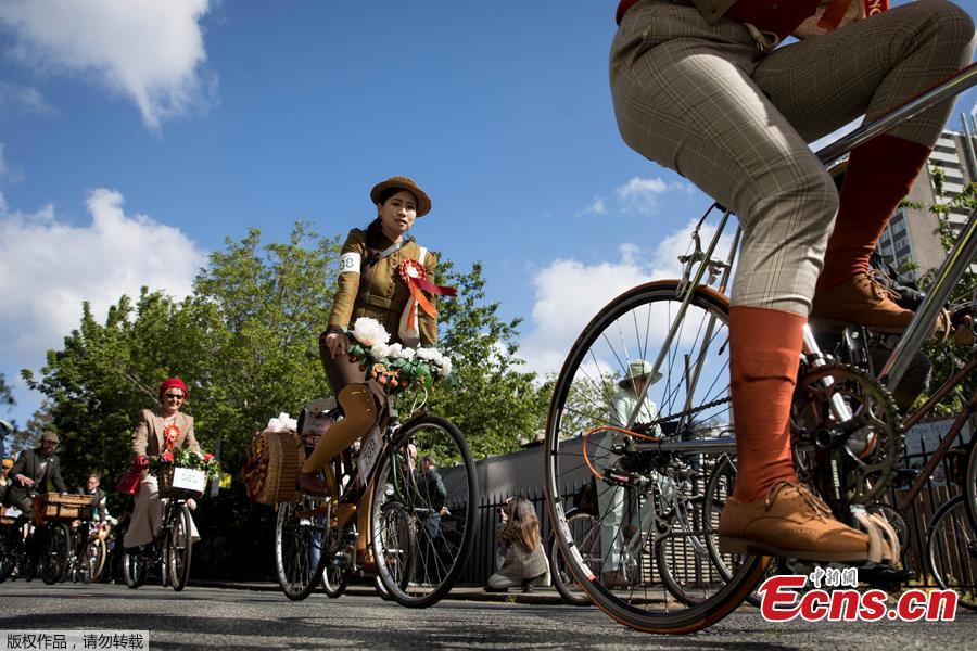 Participants ride their bicycles as they take part in the annual Tweed Run across London, Britain May 4, 2019. They ride through London\'s historic streets, stopping mid way for a picnic and ending with a traditional British \