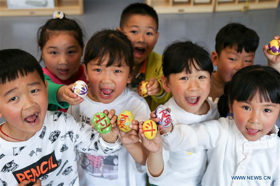 Children show painted eggs to mark the upcoming \