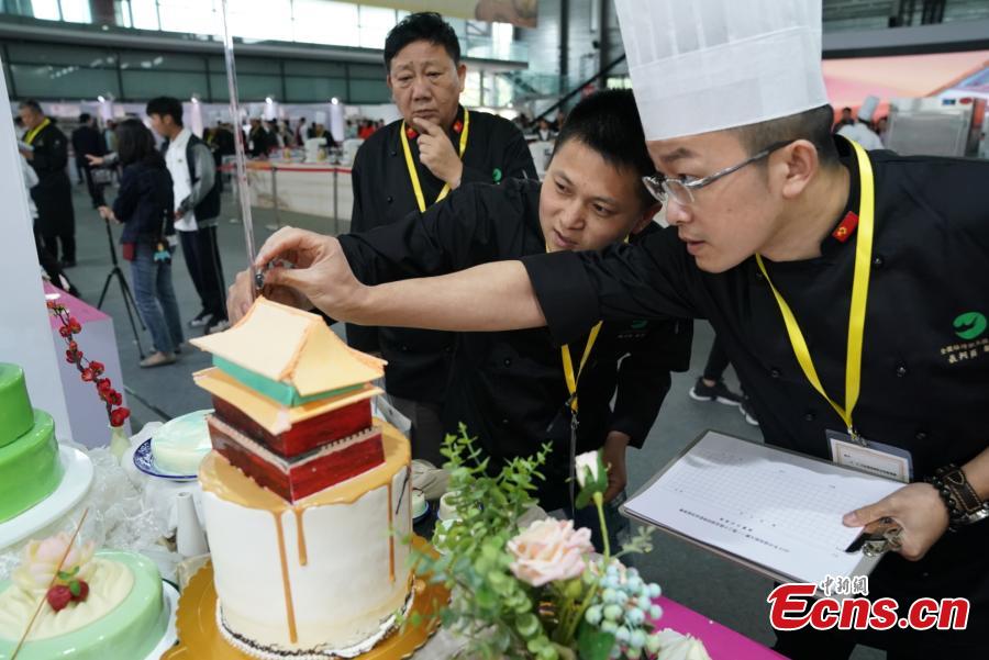 Participants compete in the 20th National Baking Skills Competition held at the Shanghai New International Expo Center, May 6, 2019. Eighty bakers from across the country took part in the competition organized by the China Association of Bakery and Confectionery Industry as well as other career guidance and industrial agencies. (Photo: China News Service/Wang Xin)
