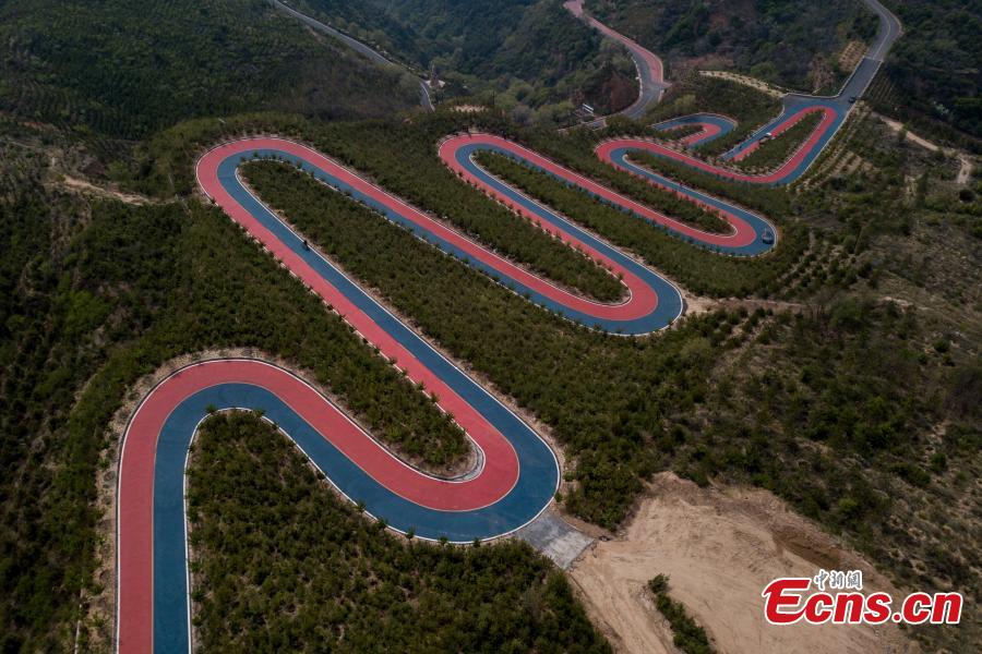 A drone photo shows a mountain road painted in two colors, used in a cycling race, in Taiyuan City, North China\'s Shanxi Province, May 7, 2019. (Photo: China News Service/Wei Liang)