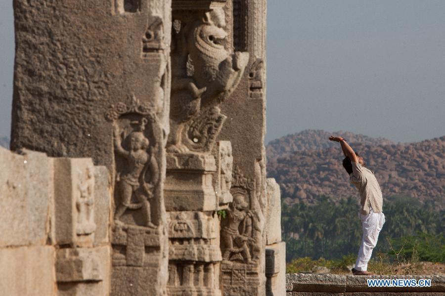 A man practices yoga at Hampi in Bellary District of India\'s state of Karnataka, Feb. 7, 2015. China will hold the Conference on Dialogue of Asian Civilizations starting from May 15. Under the theme of \