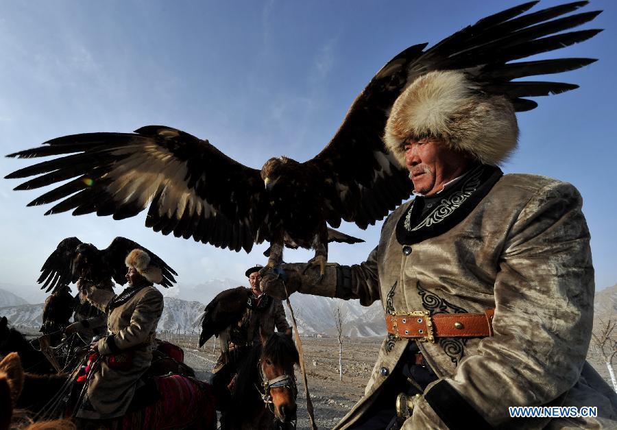 Herdsmen of Kirgiz ethnic group ride with their falcons in Akqi County, northwest China\'s Xinjiang Uygur Autonomous Region, March 20, 2011. China will hold the Conference on Dialogue of Asian Civilizations starting from May 15. Under the theme of \