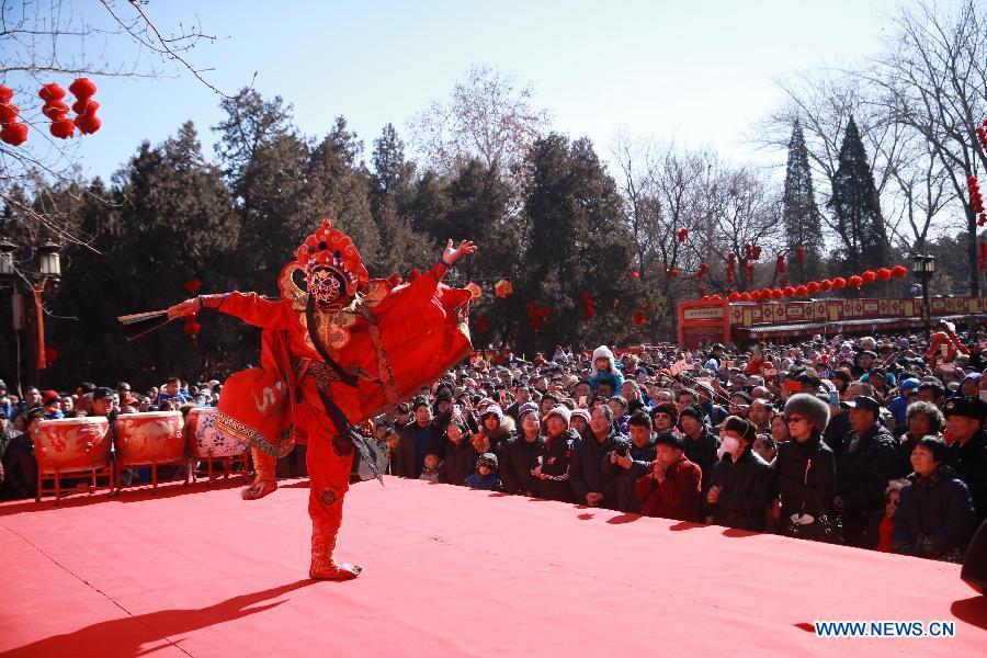 A folk artist performs Sichuan Opera face-changing during a Spring Festival temple fair at Ditan Park in Beijing, capital of China, Feb. 16, 2018. China will hold the Conference on Dialogue of Asian Civilizations starting from May 15. Under the theme of \