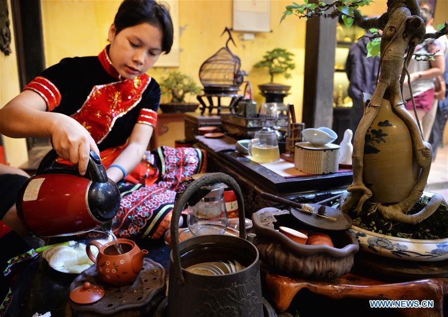 A tea artist performs tea art in Hanoi\'s Old Quarter, Vietnam, on Nov. 25, 2018. As an important part of Asian culture, tea is a special bond among Asian countries to deepen friendship and boost mutual exchanges. China will hold the Conference on Dialogue of Asian Civilizations starting from May 15. Under the theme of \