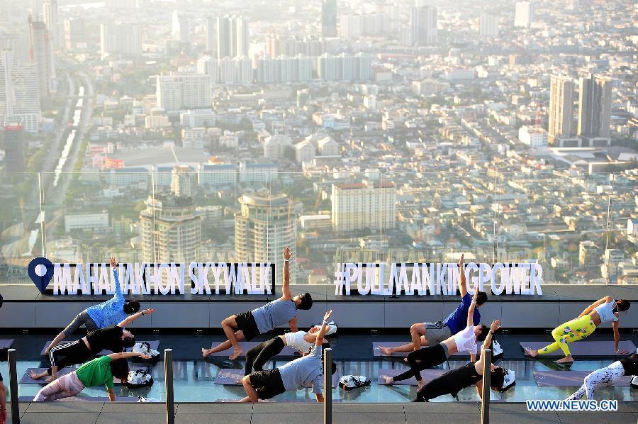 People practice yoga at an observation deck on the rooftop of a skyscraper in Bangkok, capital of Thailand, Feb. 19, 2019. China will hold the Conference on Dialogue of Asian Civilizations starting from May 15. Under the theme of \