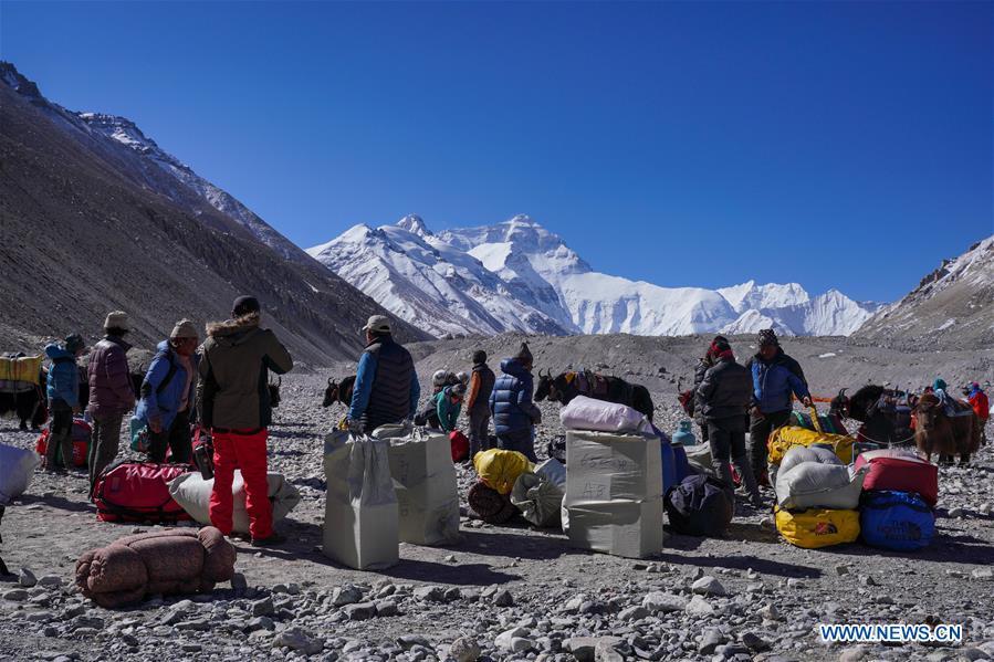 Goods and materials are to be transported to the camps at higher altitude for the climbers on the northern face of Mount Qomolangma in southwest China\'s Tibet Autonomous Region, April 25, 2019. Every year, for a few weeks, hundreds of climbers and supporting personnel come to the base camp of the northern face of Mount Qomolangma, trying to reach the summit of the tallest and most famous mountain in the world. Before starting climbing, they need to hike several times between elevations from 5,000 meters to 7,000 meters, giving their bodies some time to adapt. When this process is over, it\'s all up to the weather. The base camp is a popular place to wait for the window. Among the six camps on the northern face, the base camp at an altitude of 5,200 meters is the furthest cars can reach and therefor the most equipped. Besides food and accommodation, climbers can also enjoy tea and massage. They can also play football on perhaps the highest field. There\'s even a simple gym in the camp. Environmental protection is a priority here. Garbage sacks are given to each climbing team. Special containers are put in every camp to collect trash and sewage. The collected trash must be treated 100 kilometers away, and the only road is a zigzagging track. It is not trucks, but yaks that are generally used to make the journey. Actually yaks are vital on the mountain. Beyond the base camp, yak is the only reliable transport. (Xinhua/Sun Fei)