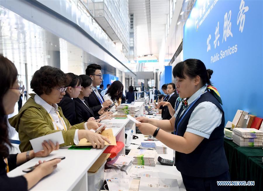 Reporters buy commemorative envelopes at the media center of the Conference on Dialogue of Asian Civilizations in the China National Convention Center in Beijing, capital of China, May 14, 2019. The Conference on Dialogue of Asian Civilizations will open on Wednesday. (Xinhua/Wang Yuguo)