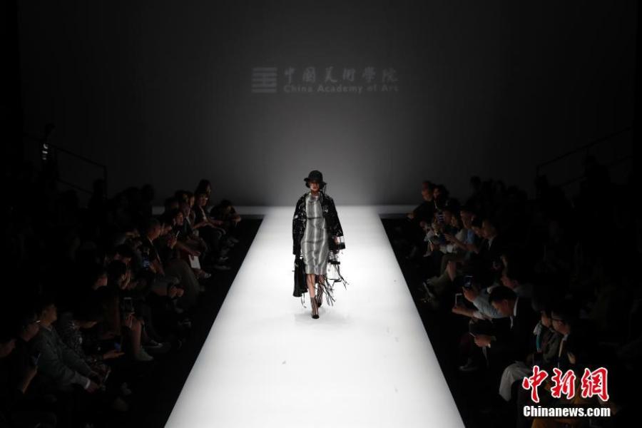 Models present creations by graduates from the School of Design at the China Academy of Art during the China Graduate Fashion Week in Beijing, May 13, 2019. A total of 1,716 graduates from 47 universities in China, South Korea and the United Kingdom will host 46 shows during the fashion week. (Photo: China News Service/Han Haidan)