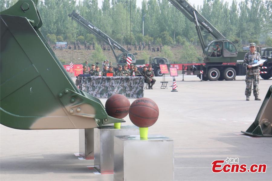 A unit of the People\'s Liberation Army Rocket Force held a skills contest where 100 military engineers competed to maneuver vehicles and machines including excavators, loaders, cranes, and forklifts passed various obstacles. (Photo: China News Service/Fang Lei)