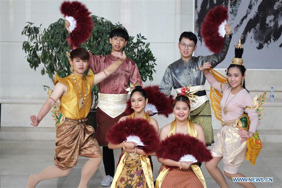 Ratjirot Aekkawat (R back) practices the Thai dance with other Thai students at the Peking University in Beijing, capital of China, Oct. 21, 2018. Ratjirot Aekkawat is of mixed blood from China and Thailand. He came to study in China as a junior student and now he is a postgraduate student of the Peking University. He always talks about his experience in China with relatives and friends. He has witnessed the development of China in recent years, during which the environment and local governments\' working efficiencies have been greatly improved. Chinese and Thai cultures are influenced with each other. Many Thai people celebrate the Spring Festival every year and lots of Chinese go to Thailand for tourism. The photo of the historical site of Ayutthaya Dynasty taken by Ratjirot Aekkawat will be displayed in a photographic exhibition \